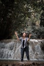 Young woman having fun under waterfalls Royalty Free Stock Photo