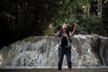 Young woman having fun under waterfalls Royalty Free Stock Photo