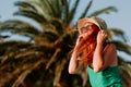 Young woman in the wind by the palm trees Royalty Free Stock Photo