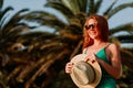 Young woman in the wind by the palm trees Royalty Free Stock Photo