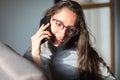 Young woman having a fun conversation over phone at home Royalty Free Stock Photo