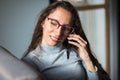 Young woman having a fun conversation over phone at home Royalty Free Stock Photo