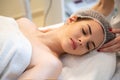 Young woman having head massage in beauty salon. Royalty Free Stock Photo