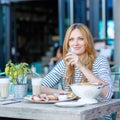 Young woman having healthy breakfast in outdoor cafe Royalty Free Stock Photo