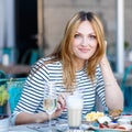 Young woman having healthy breakfast in outdoor cafe Royalty Free Stock Photo