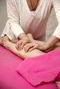 Young woman having massage in spa salon studio. Royalty Free Stock Photo