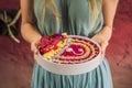 Young woman having a mediterranean breakfast, eats Healthy tropical breakfast, smoothie bowl with tropical fruits Royalty Free Stock Photo