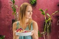 Young woman having a mediterranean breakfast, eats Healthy tropical breakfast, smoothie bowl with tropical fruits Royalty Free Stock Photo