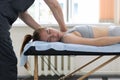 Young woman having osteopathy treatment in the cabinet