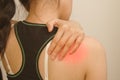 Young woman having pain in her shoulder