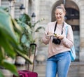 Young woman having pamphlet looking for route