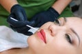 Young woman having permanent makeup on her lips at the beautician salon Royalty Free Stock Photo