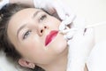 Young woman having permanent makeup on her lips at the beauticians salon Royalty Free Stock Photo