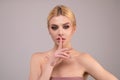 Young woman having secret while holding finger on lips and showing silence sign. Shh sign. Beautiful woman with silent Royalty Free Stock Photo