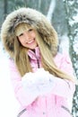 Young woman having a walk in winter forest Royalty Free Stock Photo