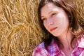 Young woman in haystack