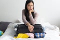 Young woman headache with overload suitcase packed because too many things in the luggage Royalty Free Stock Photo