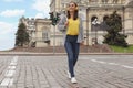 Young woman with headphones crossing street. Traffic rules and regulations Royalty Free Stock Photo