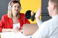 Young woman in headphones interviewing man on radio station Royalty Free Stock Photo