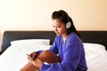 Young woman in headphones listening to the music in bed Royalty Free Stock Photo