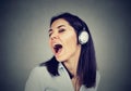 Young woman with headphones singing