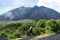 A young woman heads to the upper part of the Pacaya volcano in Guatemala.