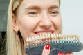 Young woman with health teeth and hold teeth whitening tool