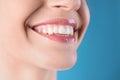 Young woman with healthy teeth and beautiful smile on color background, closeup Royalty Free Stock Photo