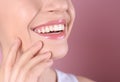 Young woman with healthy teeth and beautiful smile on color background, closeup. Royalty Free Stock Photo