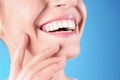 Young woman with healthy teeth and beautiful smile on color background, closeup. Royalty Free Stock Photo