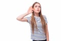 Young woman with a hearing disorder or hearing loss cupping her hand behind her ear with her