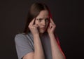 Young woman with heavy sharp headache, holding her temples with pain and hurt