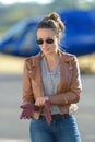 Young woman helicopter pilot putting gloves on Royalty Free Stock Photo