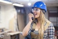 young woman with a helmet using radio communication device Royalty Free Stock Photo