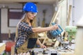 young woman with helmet working in a workshop Royalty Free Stock Photo