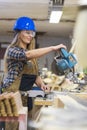 young woman with helmet working in a workshop Royalty Free Stock Photo