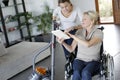 Young woman helping disabled lady