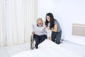 Young woman helping her father get down from wheelchair Royalty Free Stock Photo