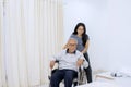 Young woman helping her father on wheelchair Royalty Free Stock Photo