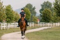 Young woman and her red horse during a calm trail ride Royalty Free Stock Photo