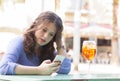 Young woman on her break reading a text message on the mobile Royalty Free Stock Photo