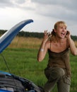 Young woman and her broken car