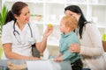 Young woman and her child at the doctor homeopaths. Royalty Free Stock Photo