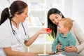 Young woman and her child at the doctor homeopaths. Royalty Free Stock Photo