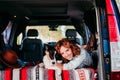 young woman and her cute border collie dog relaxing in a van. travel concept