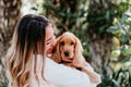 young woman and her cute puppy of cocker spaniel outdoors in a park Royalty Free Stock Photo