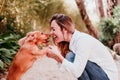 young woman and her cute puppy of cocker spaniel outdoors in a park Royalty Free Stock Photo