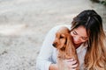 young woman and her cute puppy of cocker spaniel outdoors in a park Royalty Free Stock Photo