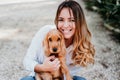 young woman and her cute puppy of cocker spaniel outdoors in a park Royalty Free Stock Photo