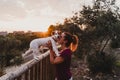 young woman and her cute small jack russell terrier dog watching sunset outdoors in a park. Golden hour. Love for animals concept Royalty Free Stock Photo